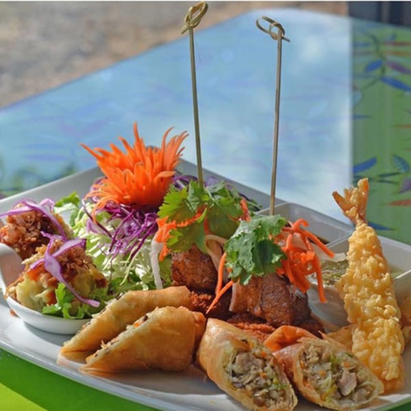 A platter of Narunya's Thai appetizers, including spring rolls, fried shrimp, and meatballs with salad.