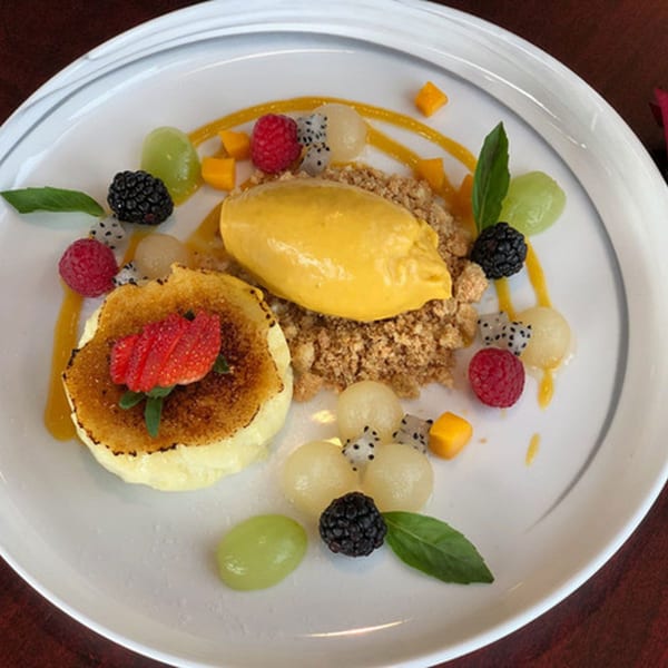 Narunya's dessert with mango ice cream, creme brulee, berries, grapes, and dragon fruit.